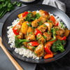 A plate of budget-friendly stir-fry with chicken and vegetables