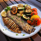 Image description: A plate of deliciously grilled fish with a side of roasted vegetables.