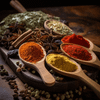 Assorted spices on a wooden spoon