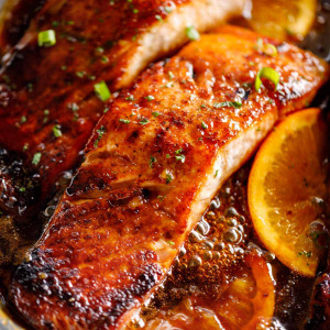 Red fish baked in a marinade with orange jam